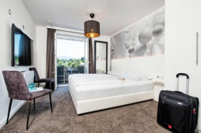 Отель Hotel 24 Checkin Velden  Фельден-Ам-Вёртер-Зе